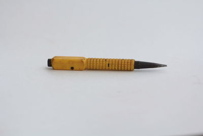 Close-up of colored pencils against white background