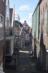 Empty alley amidst buildings in city