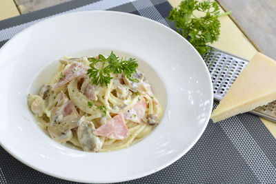 High angle view of spaghetti with cheese and meat in plate