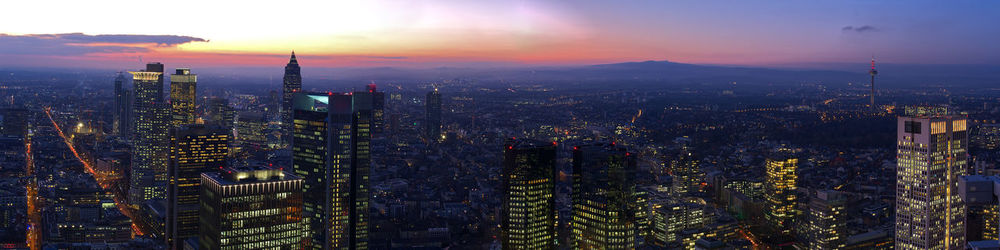 Aerial view of city lit up at sunset