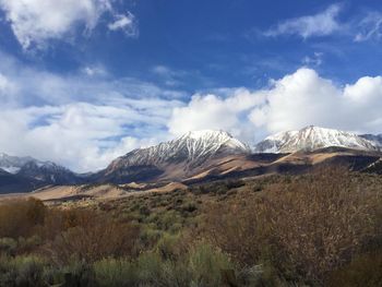 Scenic view of mountains against cloudy sky