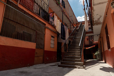 Low angle view of staircase amidst buildings in city