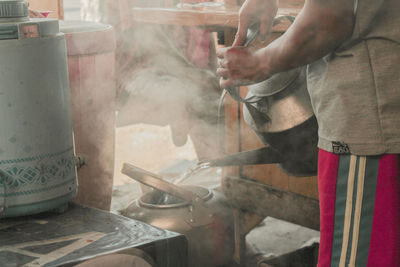 Midsection of man preparing food