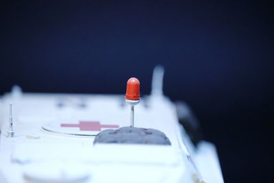 Close-up of illuminated light bulb against blue background