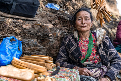 Portrait of smiling senior woman selling food