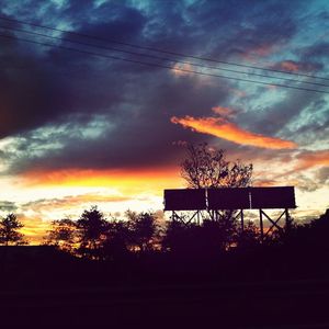 Silhouette of landscape against cloudy sky