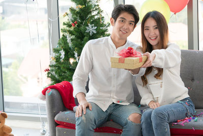 Young couple sitting outdoors