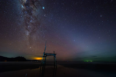 Beach against sky at night