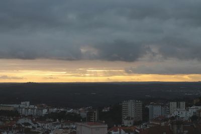 Buildings in city against sky during sunset