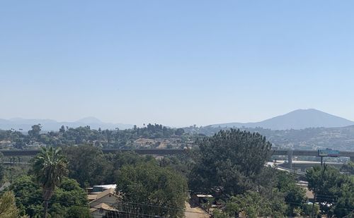 High angle view of trees and buildings against clear sky