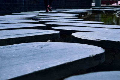 Low section of person with shadow on water