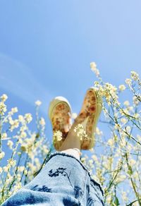 Low angle view of woman standing against sky