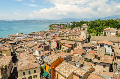 High angle view of townscape by sea against sky