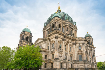 Low angle view of cathedral against cloudy sky