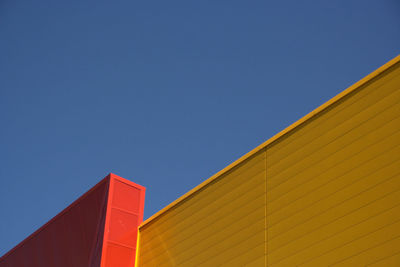 Low angle view of building against clear blue sky