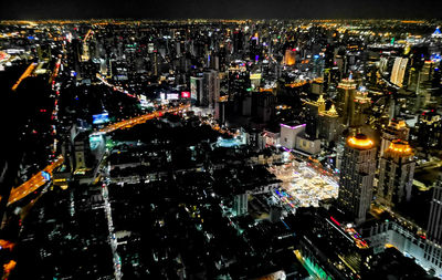 High angle view of city lit up at night