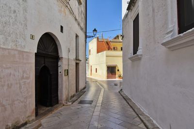 A small street between the old houses of presicce, a village in the province of lecce in italy.