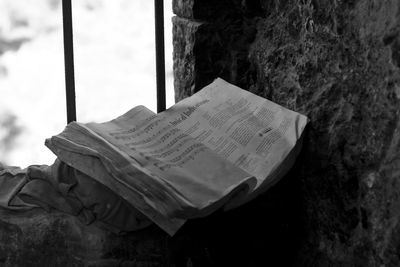 Close-up of open book against wall