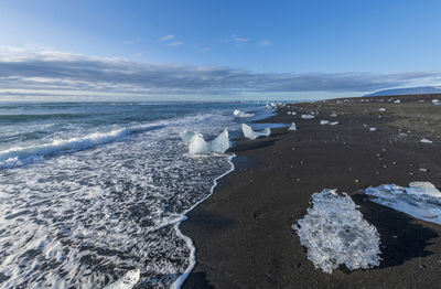 Ice formations on beach during sunrise, vestmannaeyjar, iceland, southern region