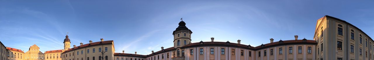 Low angle view of buildings against blue sky