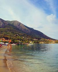 Scenic view of sea and mountains against sky