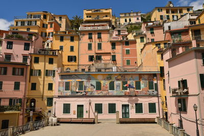 Residential buildings in city against sky