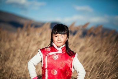 Portrait of woman standing on field