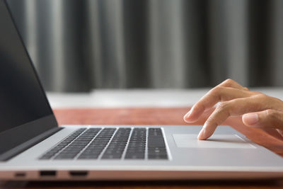 Midsection of woman using laptop