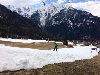 People skiing on snow covered landscape