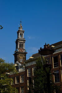 Low angle view of buildings against blue sky