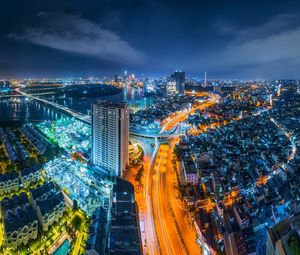 High angle view of city lit up at night