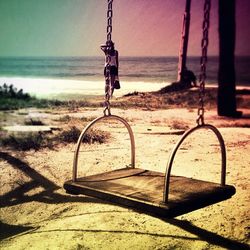 Close-up of swing on beach