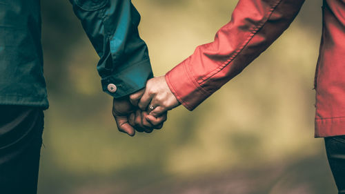 Close-up of couple holding hands