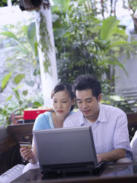 Young couple doing online shopping on laptop at home