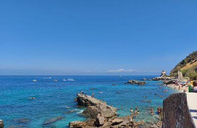 Scenic view of sea against clear blue sky