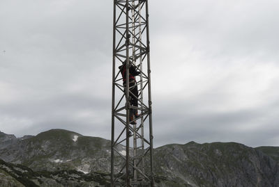 Low angle view of communications tower against sky