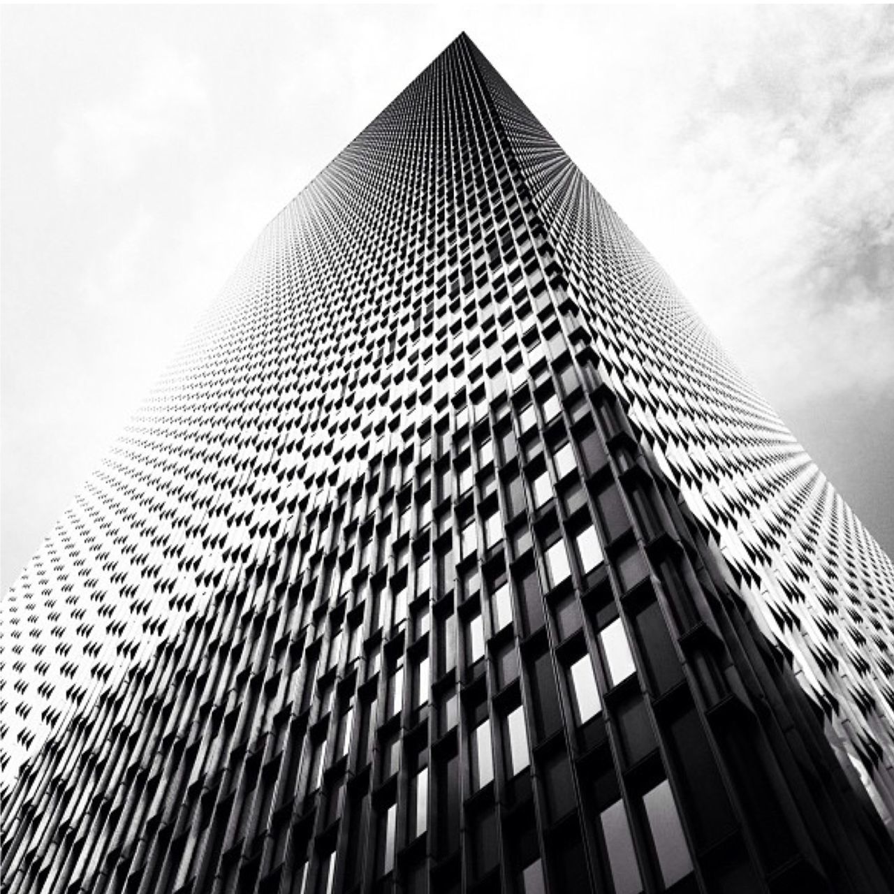 low angle view, modern, building exterior, skyscraper, architecture, built structure, tall - high, office building, sky, city, tower, building, glass - material, tall, cloud - sky, day, pattern, outdoors, no people, cloud