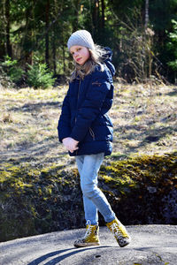 Full length portrait of girl standing on field