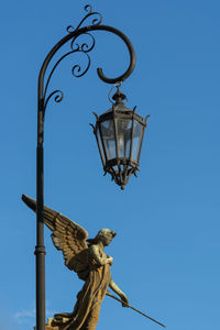 Low angle view of statue against clear blue sky