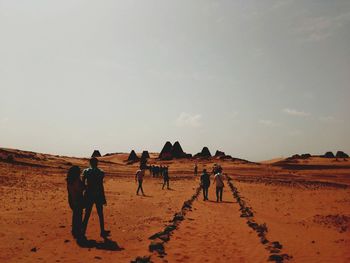 Tourists walking to see pyramids of meroe 
