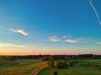 Scenic view of field against sky during sunset