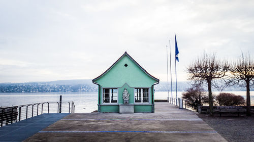 Built structure by trees against sky