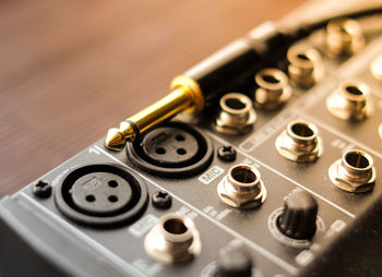 Digital music mixer closeup with a gold jack connector