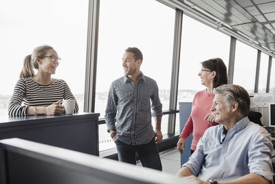 Happy business people discussing in office