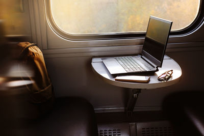 Low section of woman using laptop at home