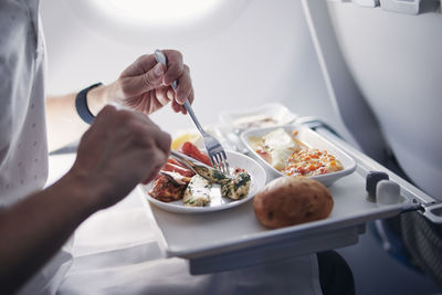 Cropped hand of woman having food