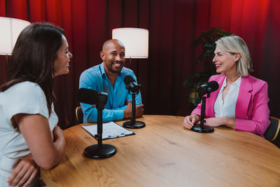 Side view of young woman sitting at home