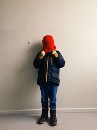 Boy pulling hat on face