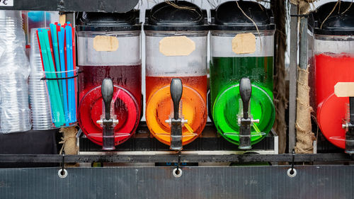 Close-up of multi colored bottles on shelf