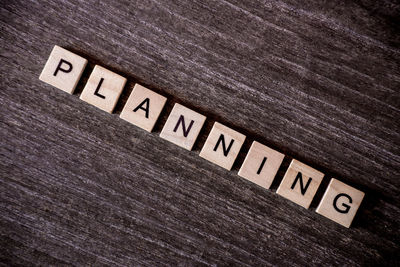 Directly above shot of wooden planning text on table